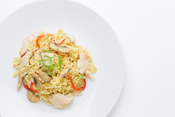 Stir-fry noodles with chicken meat, mushroom and red capsicum in a plate on white background copy space,top view