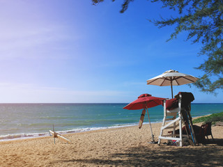 Lifeguard post on Phuket beach in late afternoon, with surfboard in view.