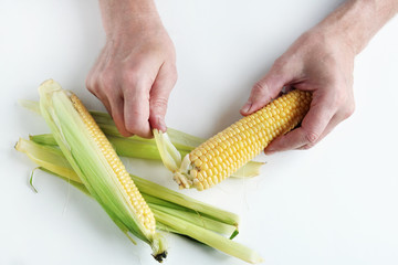 The farmer is cleaning the corn cobs