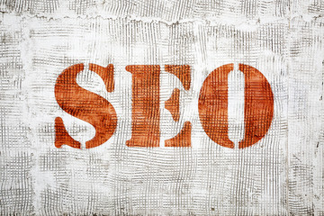 SEO sign painted on grunge stucco texture wall