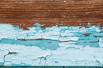 Obraz premium Old abstract colorful rusty background. Blue paint flaking and cracking on wood texture