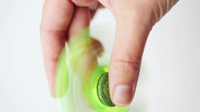 hand playing with spinning fidget spinner