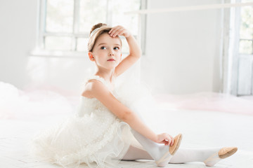 The little balerina in white tutu in class at the ballet school © master1305