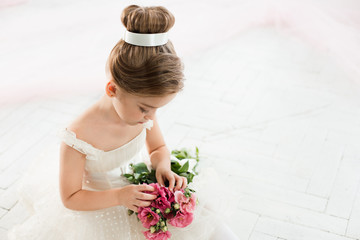The little balerina in white tutu in class at the ballet school © master1305