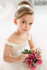 The little balerina in white tutu in class at the ballet school © master1305