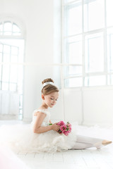 The little balerina in white tutu in class at the ballet school © master1305