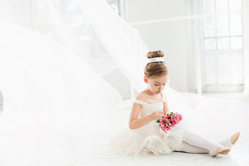 The little balerina in white tutu in class at the ballet school © master1305