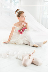 The little balerina in white tutu in class at the ballet school © master1305