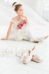 The little balerina in white tutu in class at the ballet school © master1305