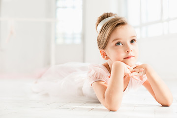 The little balerina in white tutu in class at the ballet school © master1305