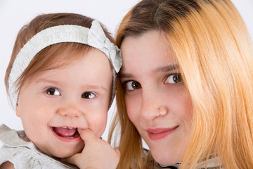 Two cousins on a white background. Infant and adult.