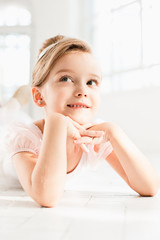 The little balerina in white tutu in class at the ballet school © master1305