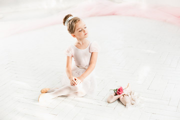 The little balerina in white tutu in class at the ballet school © master1305