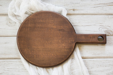 Rustic wooden cutting board on white background. Isolated. Top view and  space for your text.