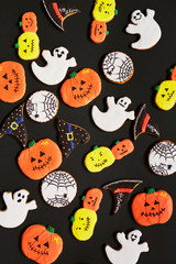 Halloween background with funny cookies in form of ghost, pumpking, hat and net
