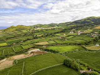 Fototapeta premium Aerial view of fields outside of the village of Ginetes in Sao Miguel Island, Portugal.