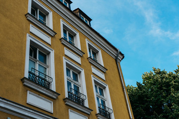Obraz premium brown facaded old building with white windows