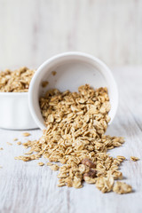 Healthy Almond Breakfast Cereal Granola Spilling From White Bowl