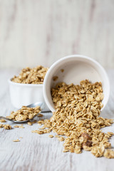 Almond Breakfast Cereal Granola Spilling From White Bowl