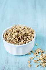 Almond Breakfast Cereal Granola In White Bowl On Blue Background