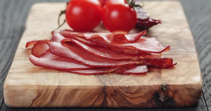 smoked ham prsut with cherry tomatoes and chili