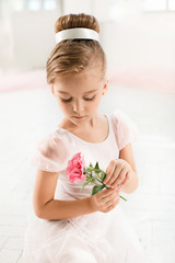 The little balerina in white tutu in class at the ballet school © master1305