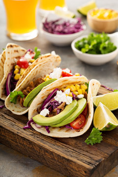 Pulled pork tacos with red cabbage and avocados