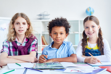 Three skilled children working in group at lesson