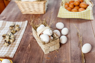 Chicken eggs in basket on wooden background