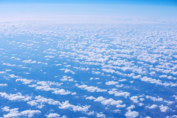View of blue sky above the clouds from airplane window
