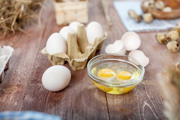 Close-up view of raw chicken eggs on wooden background