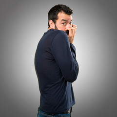 Frightened handsome man with beard on grey background