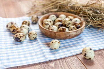 Quail eggs on the old rustic wooden table.