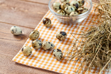 Quail eggs on the old rustic wooden table.