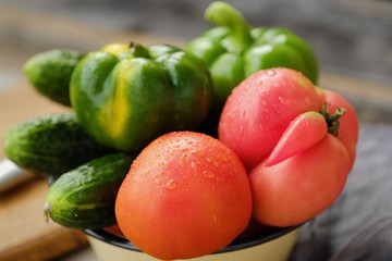 Fresh tasty vegetables on wooden background view 