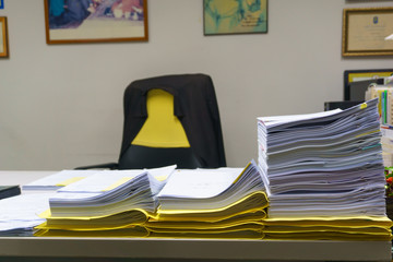 Pile of organized but unfinished business documents on desk in the office,  business and job concept