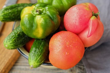 Fresh tasty vegetables on wooden background view  