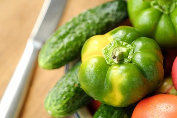 Fresh tasty vegetables on wooden background view