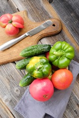 Fresh tasty vegetables on wooden background view