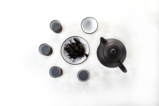 snuff cup with black tea, gaivan and a tea cup on a white backgroun