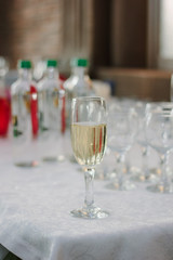 Glass filled by fresh champagne on restaurant.