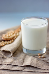 Soy milk with soy beans around it.