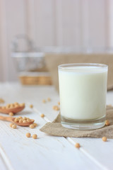 Soy milk with soy beans around it.