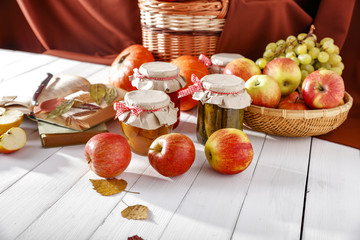 Apples pumpkin grapes on white table