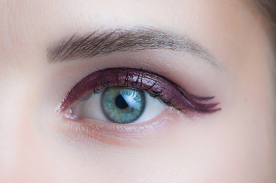 woman eye with glittering evening makeup closeup studio
