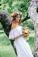 Beautiful bride in wedding dress with flower bouquet and wreast.