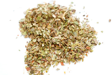 Pile of dried oregano leaves isolated on white background