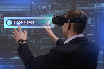 Business, Technology, Internet and network concept. Young businessman working on a virtual screen of the future and sees the inscription: E-commerce