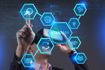 Business, Technology, Internet and network concept. Young businessman working on a virtual screen of the future and sees the inscription: Strategy