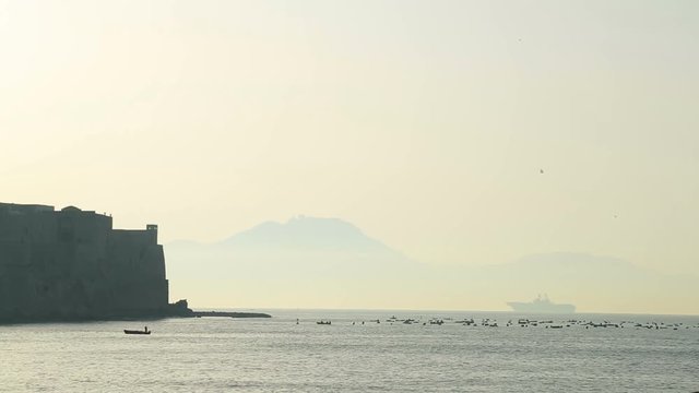 Stunning view on Castel dell Ovo, Gulf of Naples and Vesuvius mount in haze